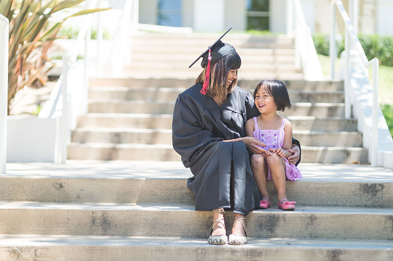 graduate student sitting next to a young child