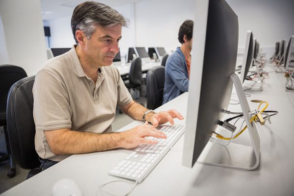 older worker at computer